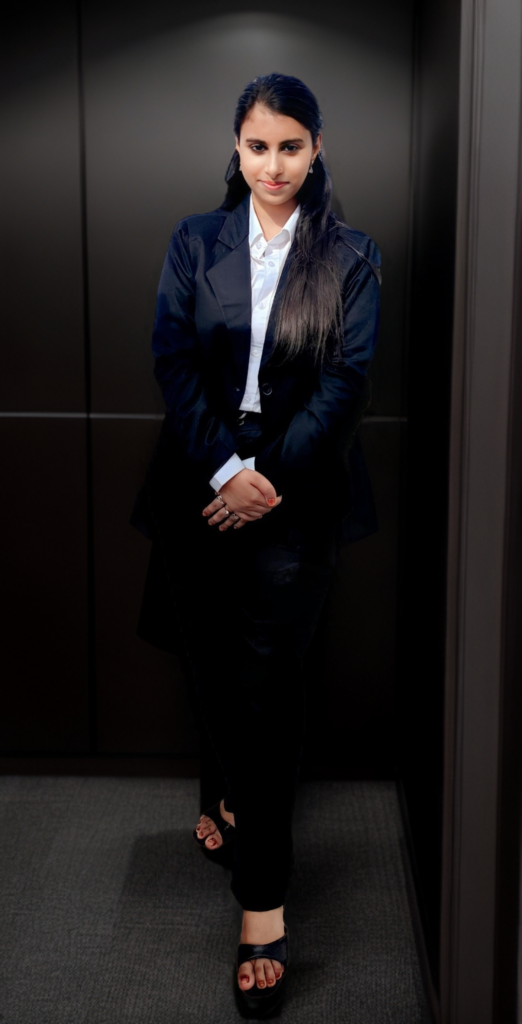 Ayesha, a standing women in front of her office